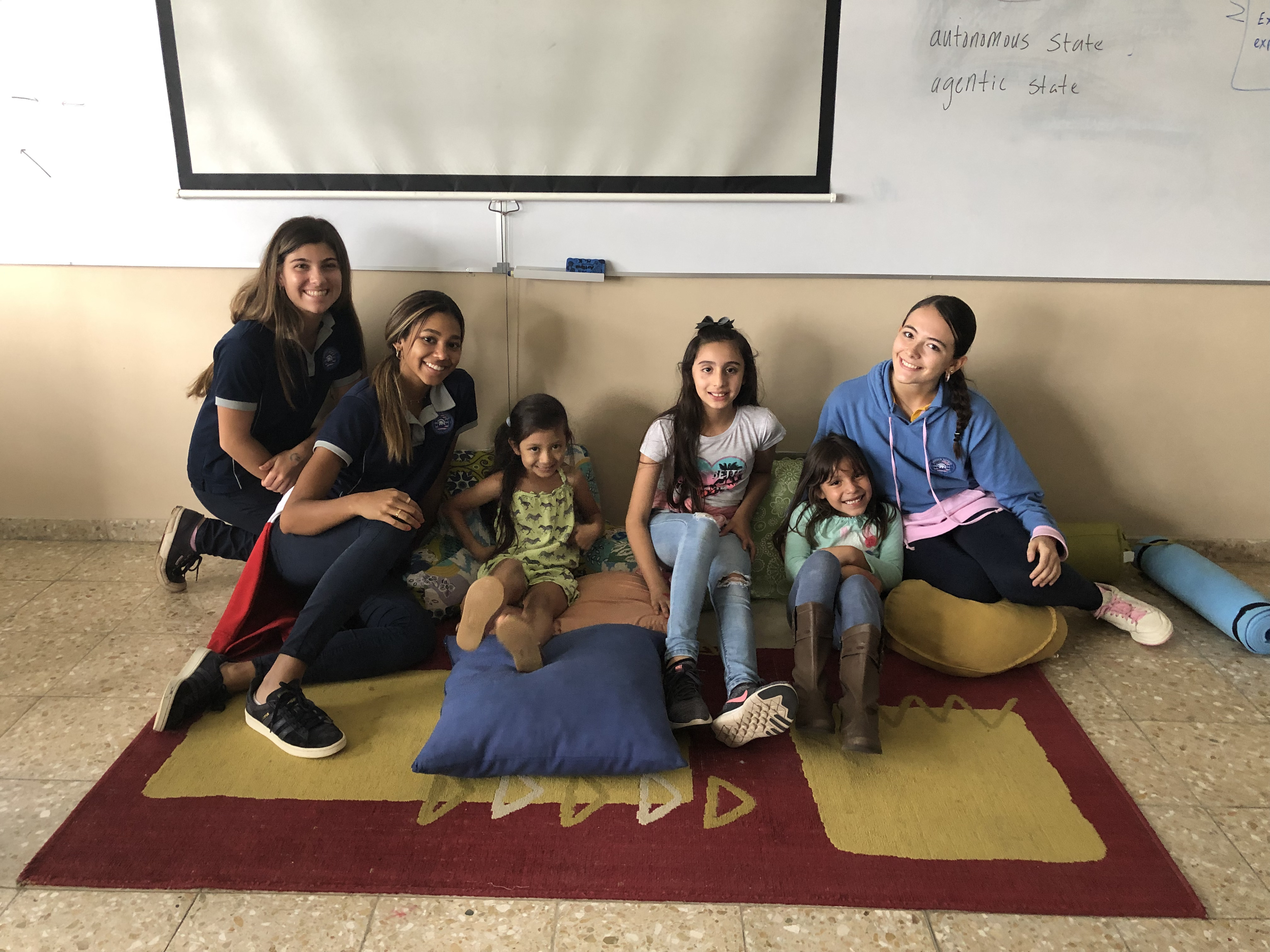 Students taking part in a lesson in front of a projected slide